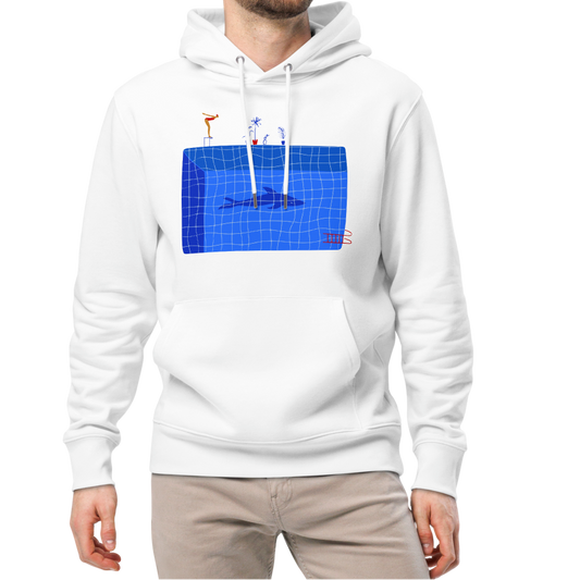 A man modeling an organic hoodie in white by Lane Line Threads featuring a graphic of a diver, potted plants, and a shark silhouette in a blue pool.