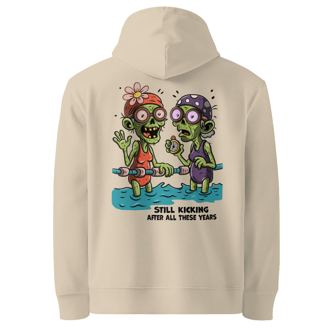 Organic hoodie in beige with cartoon zombie swimmers and “Still Kicking After All These Years” Halloween graphic by Lane Line Threads, GOTS & OCS certified cotton.