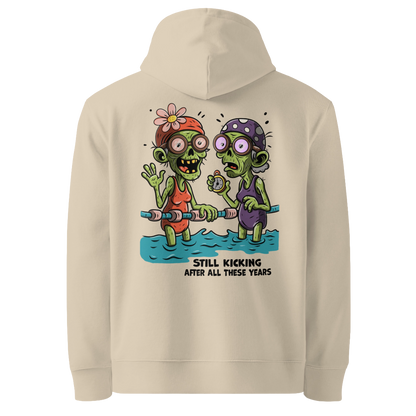 Organic hoodie in beige with cartoon zombie swimmers and “Still Kicking After All These Years” Halloween graphic by Lane Line Threads, GOTS & OCS certified cotton.