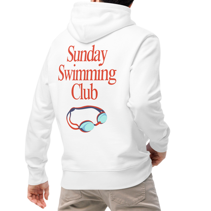 A man viewed from behind wearing an organic hoodie white Lane Line Threads sweatshirt with Sunday Swimming Club text and swim goggles graphic on the back, paired with beige pants and white sneakers, against a plain white background.