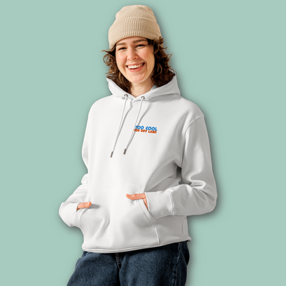 A woman wearing an organic hoodie in white with "Too Cool For Dry Land" embroidery in blue and orange, designed by Lane Line Threads for swimmer recovery and skin health.