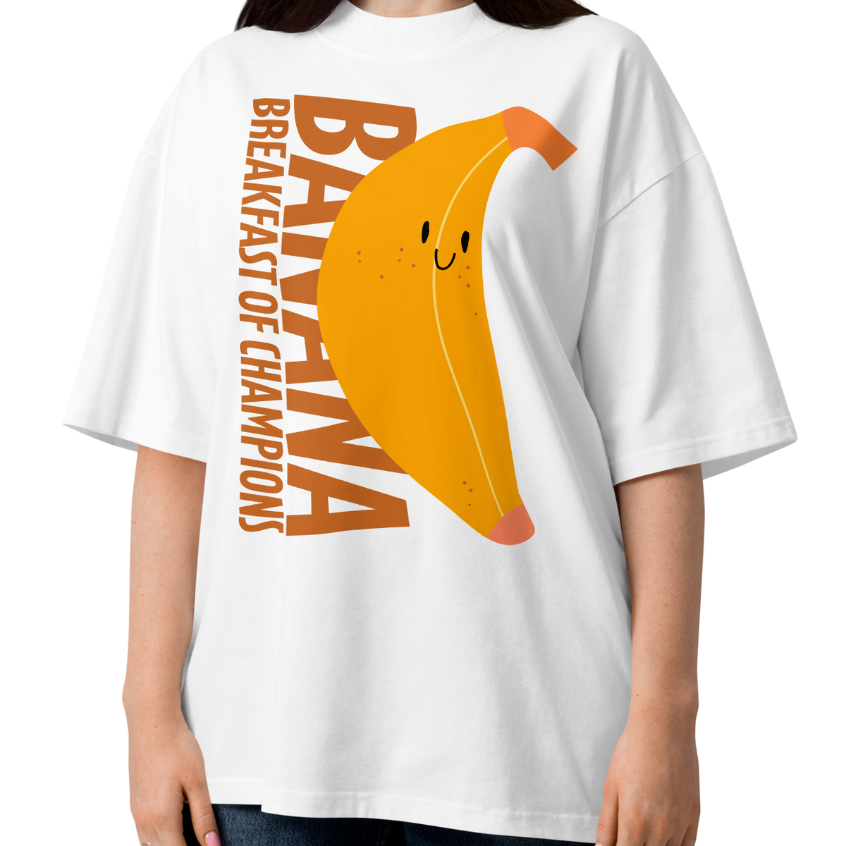 A woman modeling a white short-sleeve crewneck organic oversized t-shirt by Lane Line Threads featuring a graphic print of a smiling yellow banana with the text 'BANANA BREAKFAST OF CHAMPIONS' in brown.
