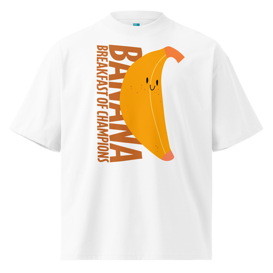 A white short-sleeve crewneck organic oversized t-shirt by Lane Line Threads featuring a graphic print of a smiling yellow banana with the text 'BANANA BREAKFAST OF CHAMPIONS' in brown.