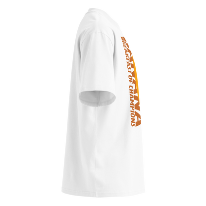 A white short-sleeve crewneck organic oversized t-shirt by Lane Line Threads featuring a graphic print of a smiling yellow banana with the text 'BANANA BREAKFAST OF CHAMPIONS' in brown, shown from the right side.