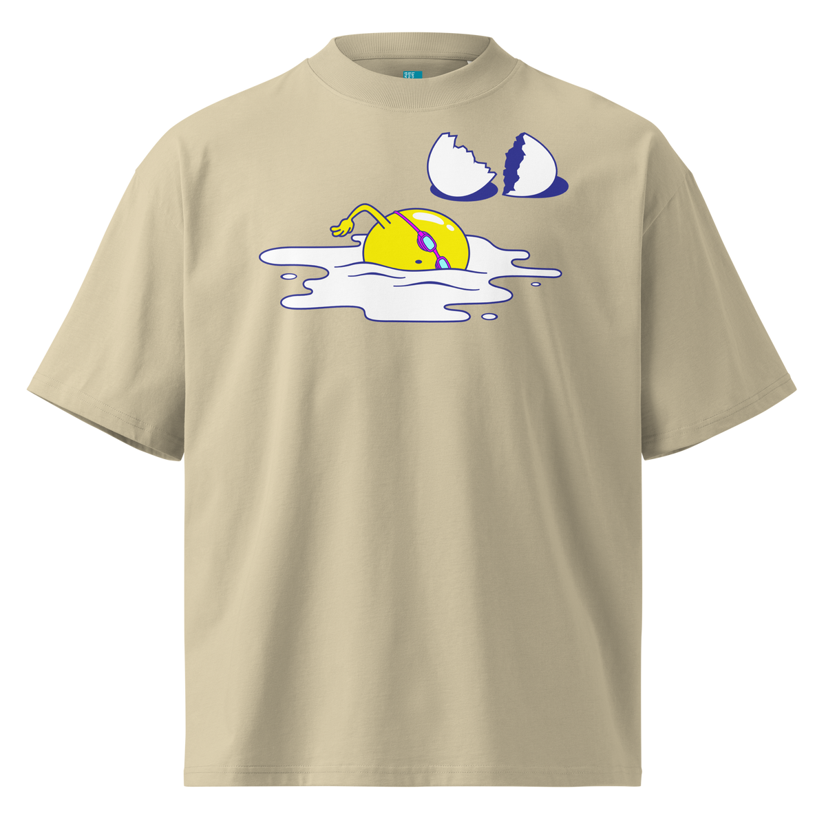 A beige short-sleeve crewneck organic oversized t-shirt by Lane Line Threads featuring a graphic print of a yellow cartoon egg yolk swimmer character breaking an egg on a white background.