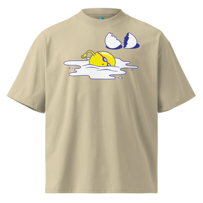 A beige short-sleeve crewneck organic oversized t-shirt by Lane Line Threads featuring a graphic print of a yellow cartoon egg yolk swimmer character breaking an egg on a white background.