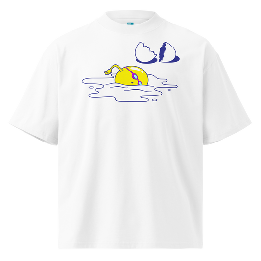 A white short-sleeve crewneck organic oversized t-shirt by Lane Line Threads featuring a graphic print of a yellow cartoon egg yolk swimmer character breaking an egg on a white background.