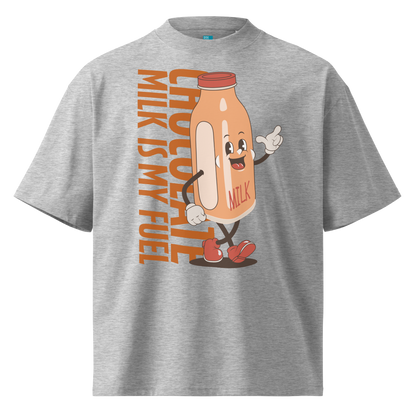 A grey short-sleeve crewneck organic oversized t-shirt by Lane Line Threads featuring a cartoon graphic of a vintage milk bottle character with the text 'CHOCOLATE MILK IS MY FUEL' printed vertically in orange and inspired by Katie Ledecky.