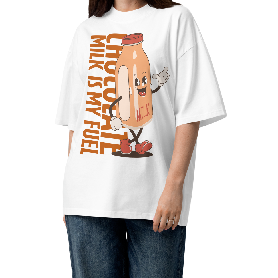 A woman modeling а white short-sleeve crewneck organic oversized t-shirt by Lane Line Threads featuring a cartoon graphic of a vintage milk bottle character with the text 'CHOCOLATE MILK IS MY FUEL' printed vertically in orange and inspired by Katie Ledecky.