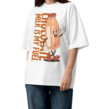 A woman modeling а white short-sleeve crewneck organic oversized t-shirt by Lane Line Threads featuring a cartoon graphic of a vintage milk bottle character with the text 'CHOCOLATE MILK IS MY FUEL' printed vertically in orange and inspired by Katie Ledecky.