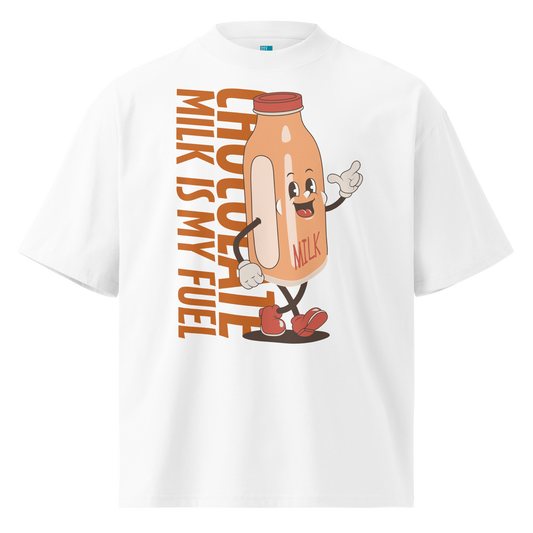 A white short-sleeve crewneck organic oversized t-shirt by Lane Line Threads featuring a cartoon graphic of a vintage milk bottle character with the text 'CHOCOLATE MILK IS MY FUEL' printed vertically in orange and inspired by Katie Ledecky.
