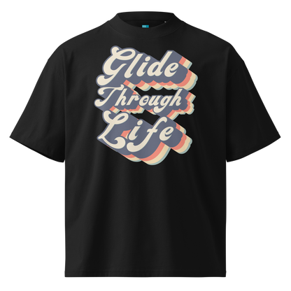 Organic oversized t-shirt by Lane Line Threads in black with retro “Glide Through Life” layered swim graphic.