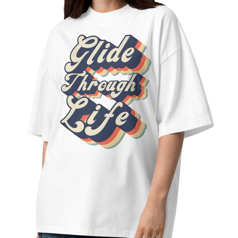 woman wearing an organic oversized t-shirt by Lane Line Threads in white with retro “Glide Through Life” layered swim graphic.