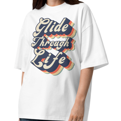 woman wearing an organic oversized t-shirt by Lane Line Threads in white with retro “Glide Through Life” layered swim graphic.