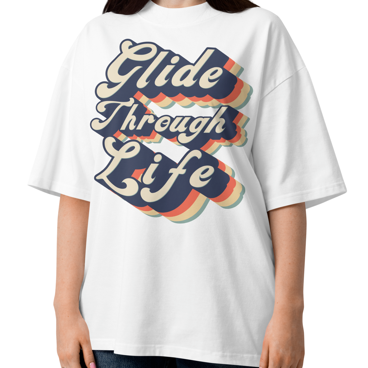A woman modeling an organic oversized t-shirt by Lane Line Threads in white with retro “Glide Through Life” layered swim graphic
