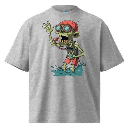 A gray short-sleeve crewneck Halloween organic oversized t-shirt by Lane Line Threads, featuring a colorful graphic of a zombie wearing a red swimming cap, swim goggles, and a black TYR tank, standing in splashing water.
