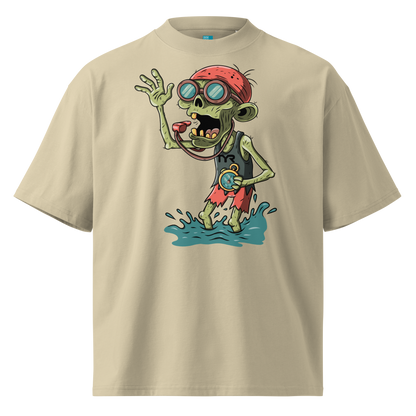 A beige short-sleeve crewneck Halloween organic oversized t-shirt by Lane Line Threads, featuring a colorful graphic of a zombie wearing a red swimming cap, swim goggles, and a black TYR tank, standing in splashing water.