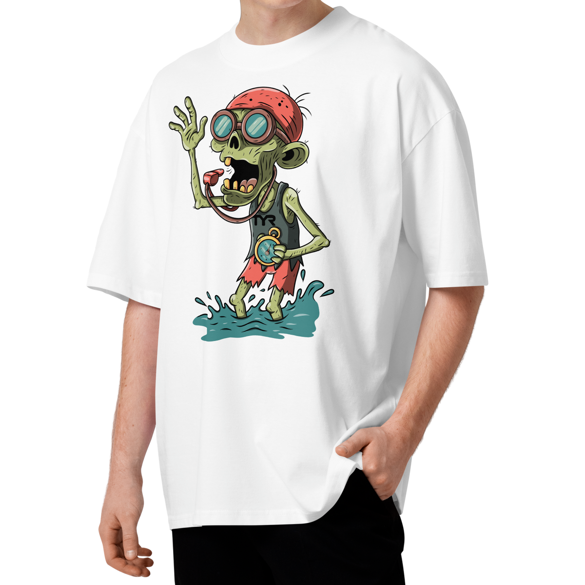 A young man with curly brown hair wearing a white short-sleeve crewneck Halloween organic oversized t-shirt by Lane Line Threads, featuring a colorful graphic of a zombie wearing a red swimming cap, swim goggles, and a black TYR tank, standing in splashing water.
