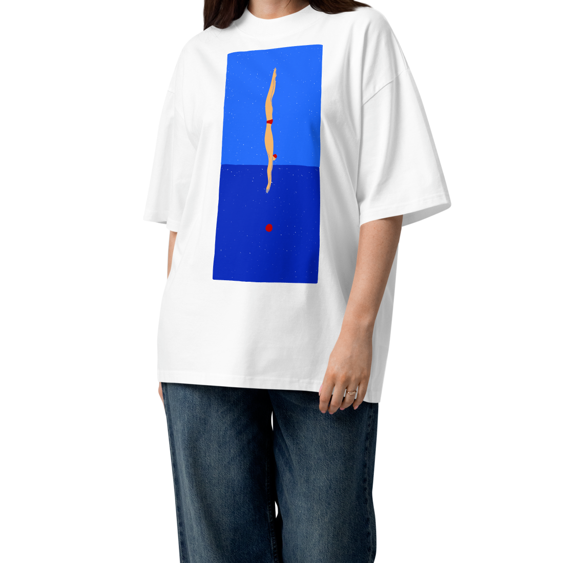 A woman modeling a white short-sleeve crewneck organic oversized t-shirt by Lane Line Threads featuring a graphic print of a minimalist figure diving into a blue water scene, displayed on a clean white background.