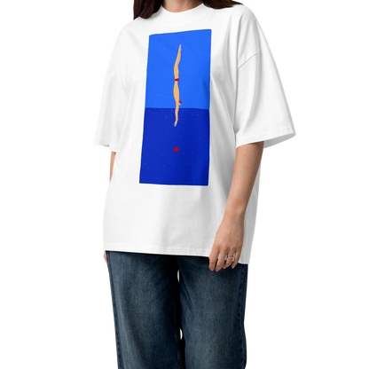 A woman modeling a white short-sleeve crewneck organic oversized t-shirt by Lane Line Threads featuring a graphic print of a minimalist figure diving into a blue water scene, displayed on a clean white background.