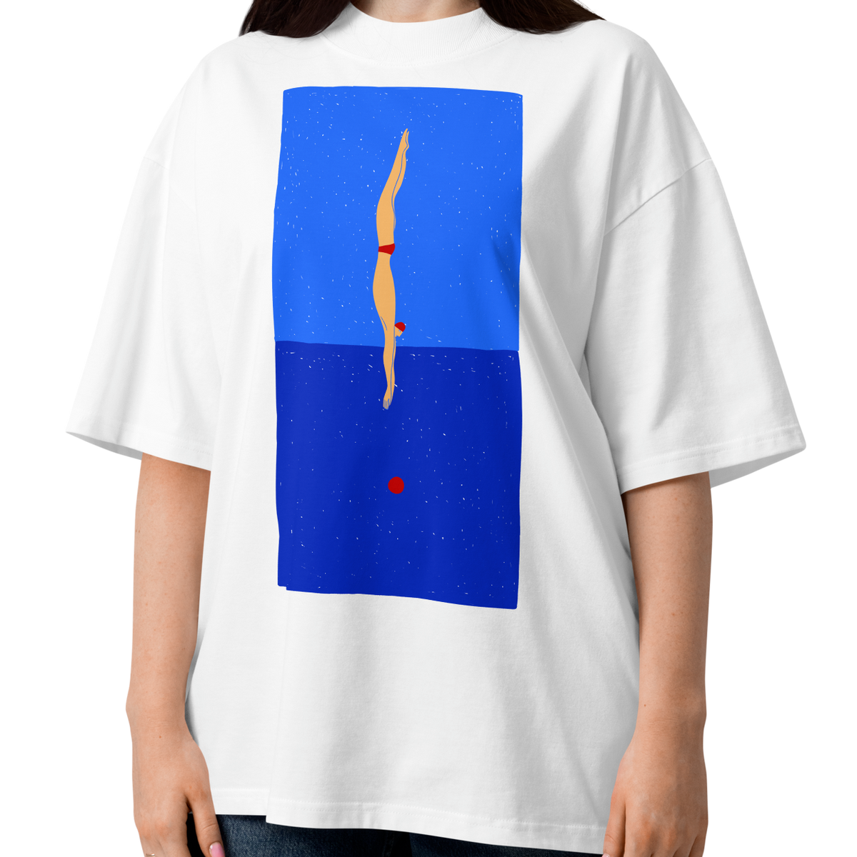 A woman modeling a white short-sleeve crewneck organic oversized t-shirt by Lane Line Threads featuring a graphic print of a minimalist figure diving into a blue water scene, displayed on a clean white background.