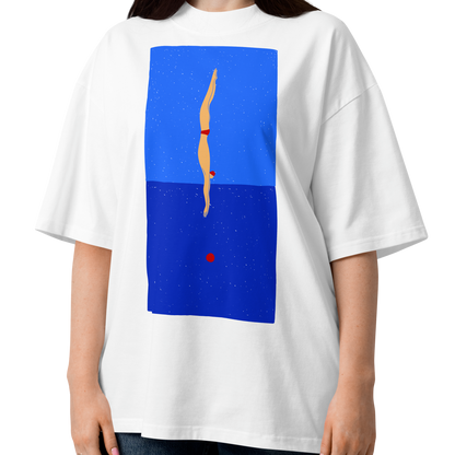 A woman modeling a white short-sleeve crewneck organic oversized t-shirt by Lane Line Threads featuring a graphic print of a minimalist figure diving into a blue water scene, displayed on a clean white background.
