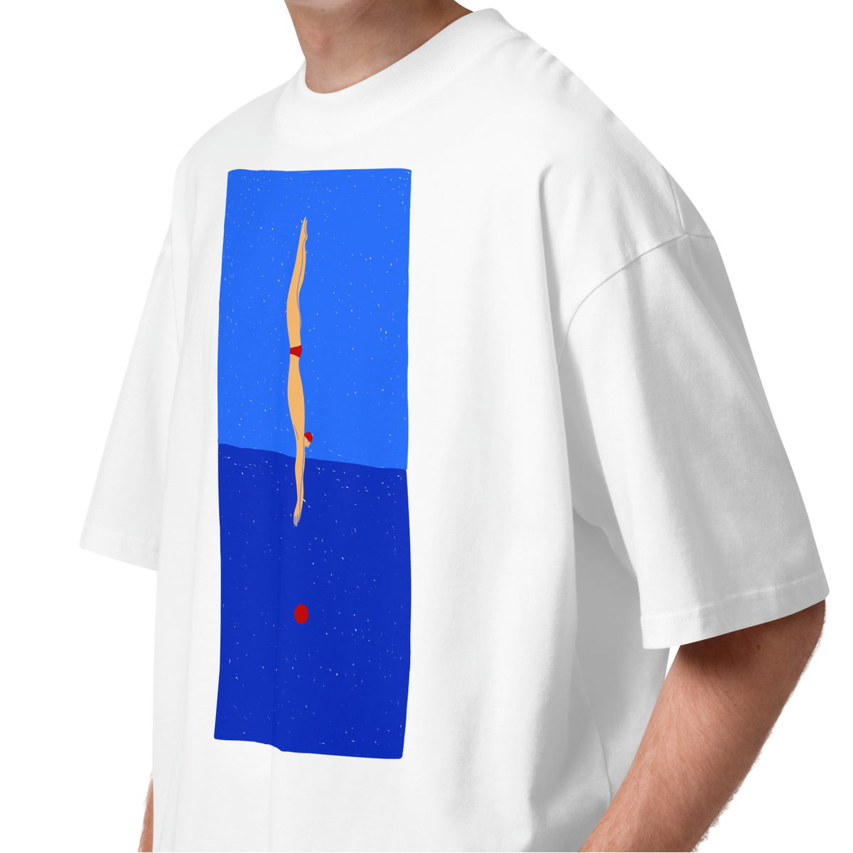 A young man with curly brown hair wearing a white short-sleeve crewneck organic oversized t-shirt by Lane Line Threads featuring a graphic print of a minimalist figure diving into a blue water scene, displayed on a clean white background.