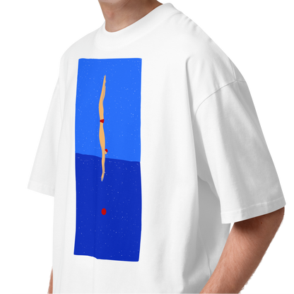 A young man with curly brown hair wearing a white short-sleeve crewneck organic oversized t-shirt by Lane Line Threads featuring a graphic print of a minimalist figure diving into a blue water scene, displayed on a clean white background.