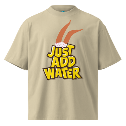A beige short-sleeve crewneck organic oversized t-shirt by Lane Line Threads featuring a graphic print of woman legs wearing a pink polka-dot swimsuit, with the text 'JUST ADD WATER' in bold yellow letters with black outlines.