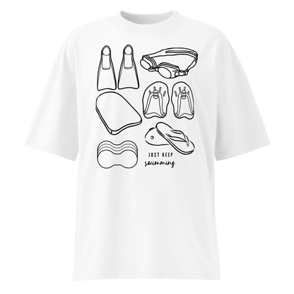 A white short-sleeve organic oversized t-shirt by Lane Line Threads with a black line art graphic of various swimming accessories (flippers, goggles, kickboard, flip-flops, swim cap) and the text 'JUST KEEP swimming' printed on the front.