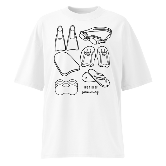A white short-sleeve organic oversized t-shirt by Lane Line Threads with a black line art graphic of various swimming accessories (flippers, goggles, kickboard, flip-flops, swim cap) and the text 'JUST KEEP swimming' printed on the front.