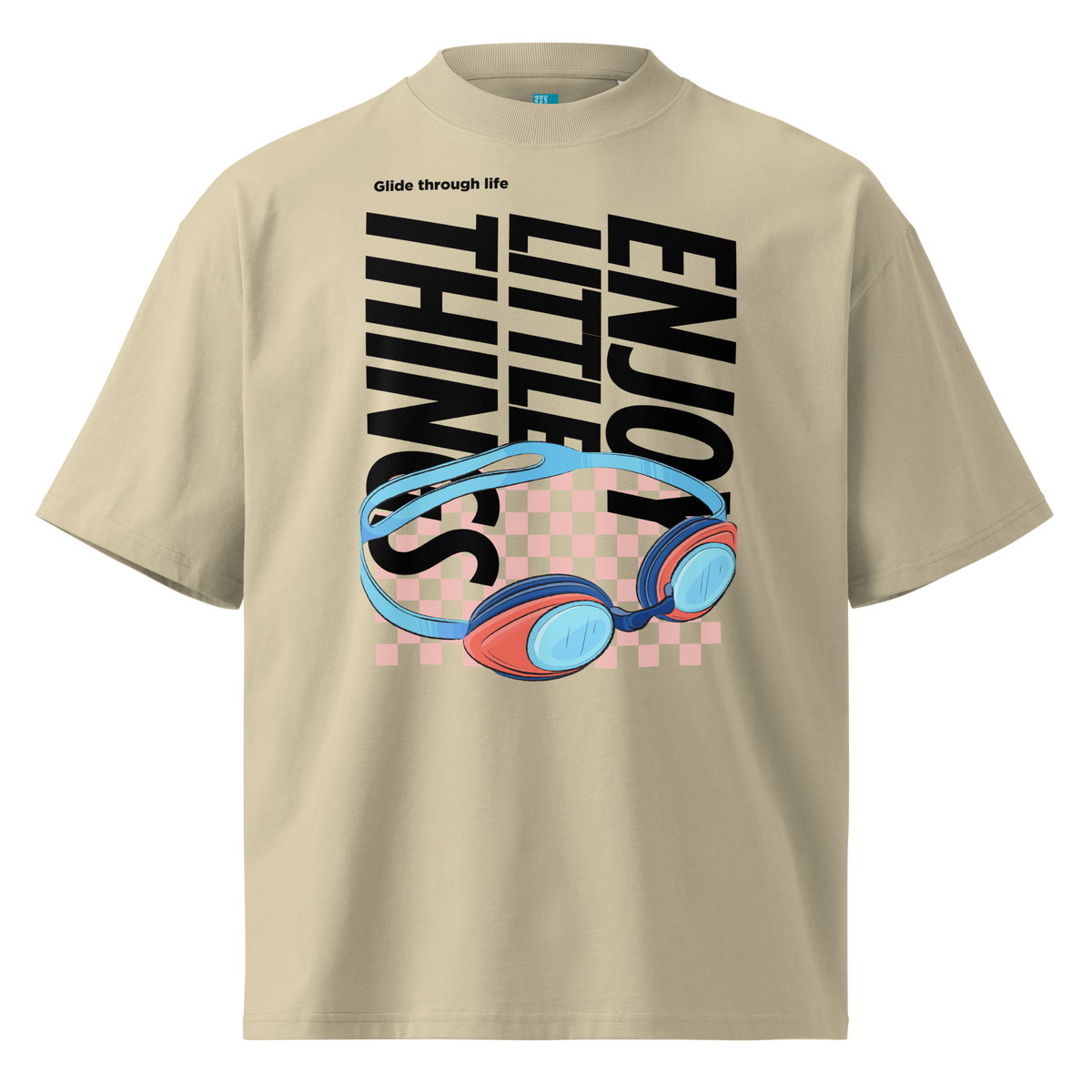 Organic oversized t-shirt in beige with colorful swim goggles, bold “Enjoy Little Things” lettering, and “Glide Through Life” graphic by Lane Line Threads.