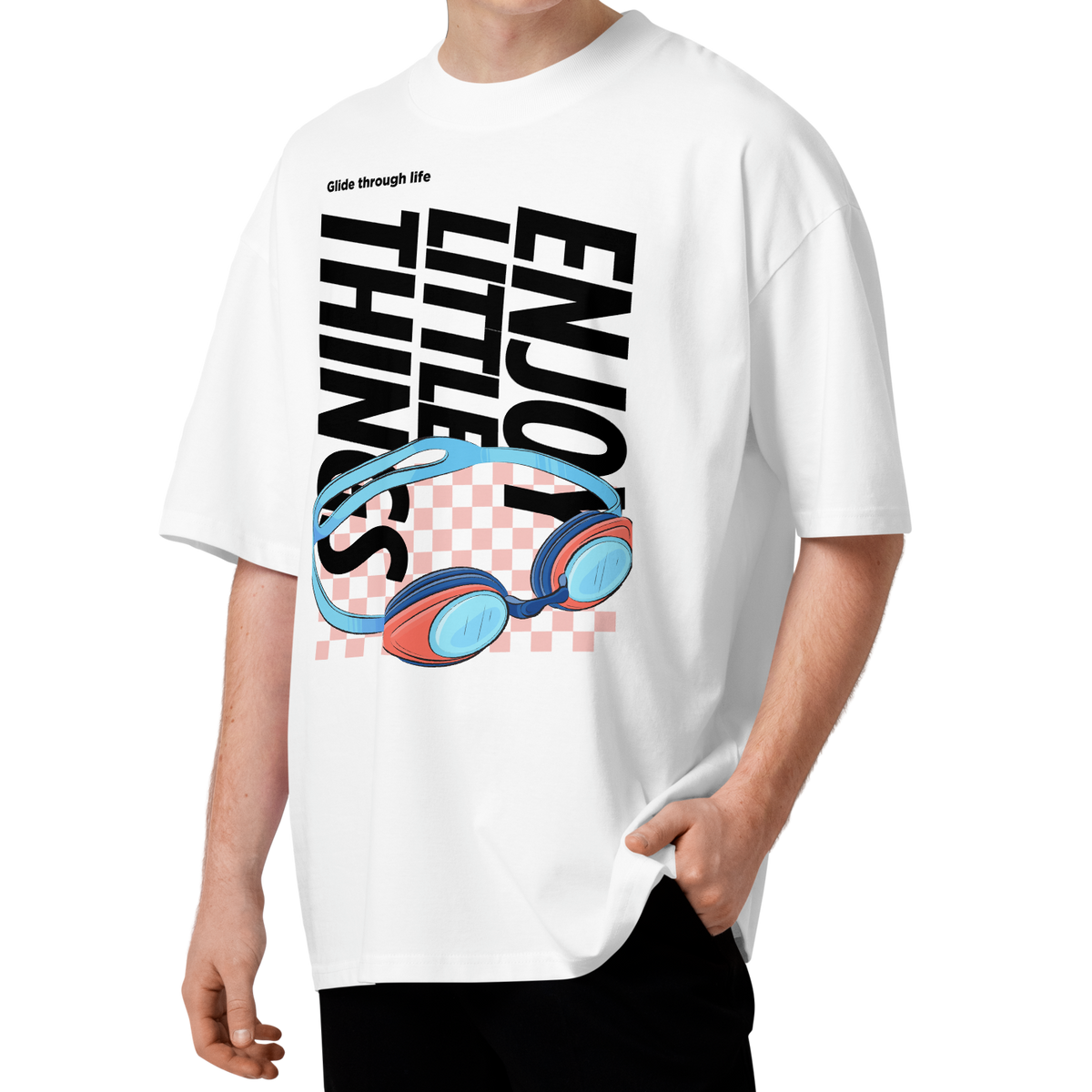 a man modeling an organic oversized t-shirt in white with colorful swim goggles, bold “Enjoy Little Things” lettering, and “Glide Through Life” graphic by Lane Line Threads.