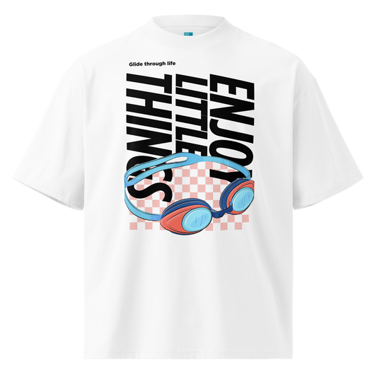 Organic oversized t-shirt in white with colorful swim goggles, bold “Enjoy Little Things” lettering, and “Glide Through Life” graphic by Lane Line Threads.