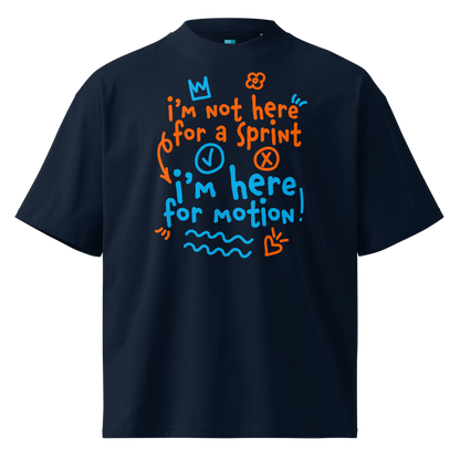 A navy short-sleeve crewneck organic oversized t-shirt by Lane Line Threads with a colorful graphic print on the chest. The graphic features the text 'I'm not here for a sprint I'm here for motion!' in orange and blue handwritten-style lettering, accompanied by small doodles of a clock, a stop sign, wavy lines, and a heart.