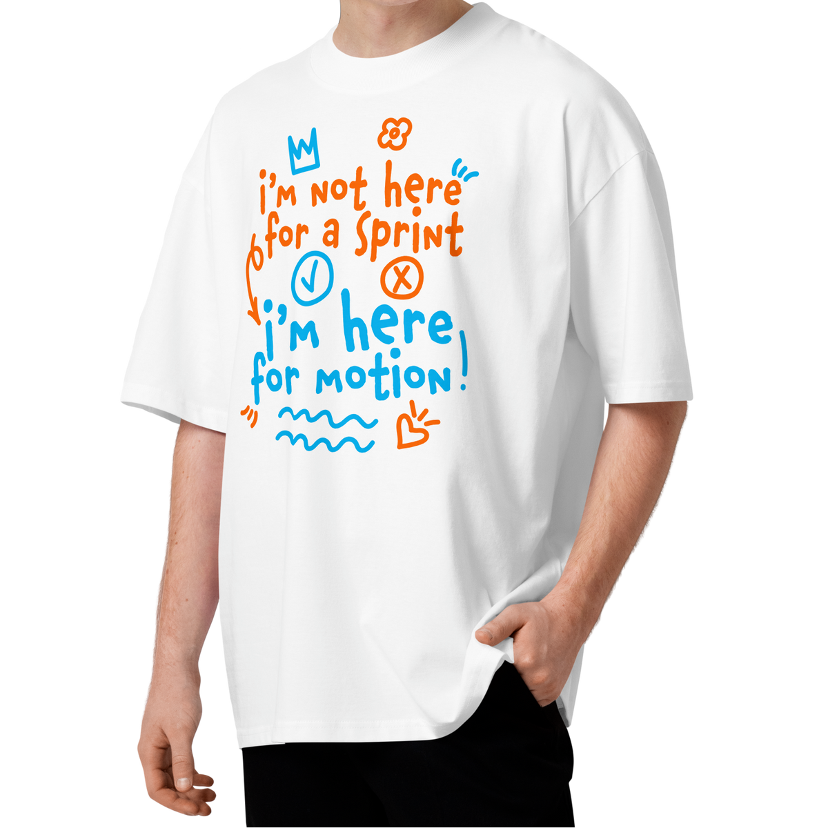 A young man with curly brown hair wearing a white short-sleeve crewneck organic oversized t-shirt by Lane Line Threads with a colorful graphic print on the chest. The graphic features the text 'I'm not here for a sprint I'm here for motion!' in orange and blue handwritten-style lettering, accompanied by small doodles of a clock, a stop sign, wavy lines, and a heart.