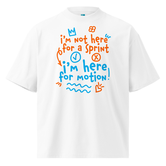 A white short-sleeve crewneck organic oversized t-shirt by Lane Line Threads with a colorful graphic print on the chest. The graphic features the text 'I'm not here for a sprint I'm here for motion!' in orange and blue handwritten-style lettering, accompanied by small doodles of a clock, a stop sign, wavy lines, and a heart.