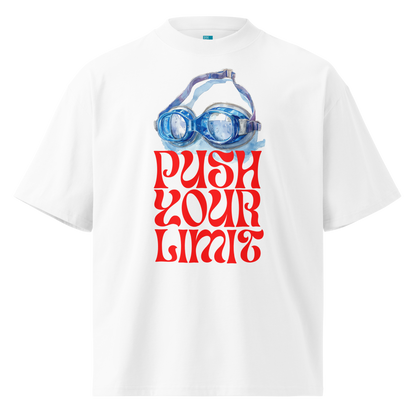A white short-sleeve crewneck organic oversized t-shirt by Lane Line Threads featuring a graphic print of blue swim goggles above the text 'PUSH YOUR LIMIT' in a bold red retro font.