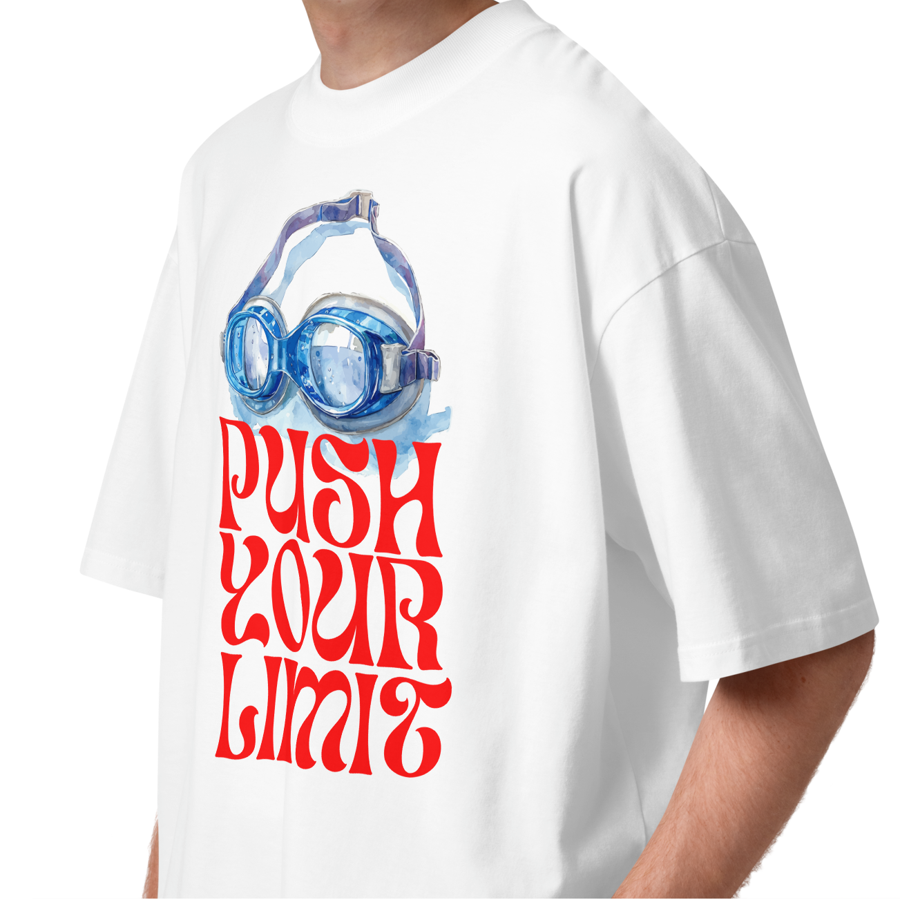 A young man wearing a white short-sleeve crewneck organic oversized t-shirt by Lane Line Threads featuring a graphic print of blue swim goggles above the text 'PUSH YOUR LIMIT' in a bold red retro font.