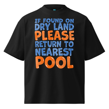 A black short-sleeve organic oversized t-shirt with a bold graphic text print reading 'IF FOUND ON DRY LAND PLEASE RETURN TO NEAREST POOL' in blue and orange lettering, shown on a plain white background.