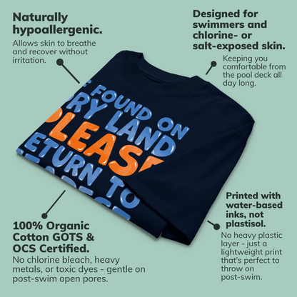 A navy blue organic oversized t-shirt with a colorful graphic print, surrounded by text callouts highlighting its hypoallergenic, chlorine-resistant, and eco-friendly properties on a light teal background.