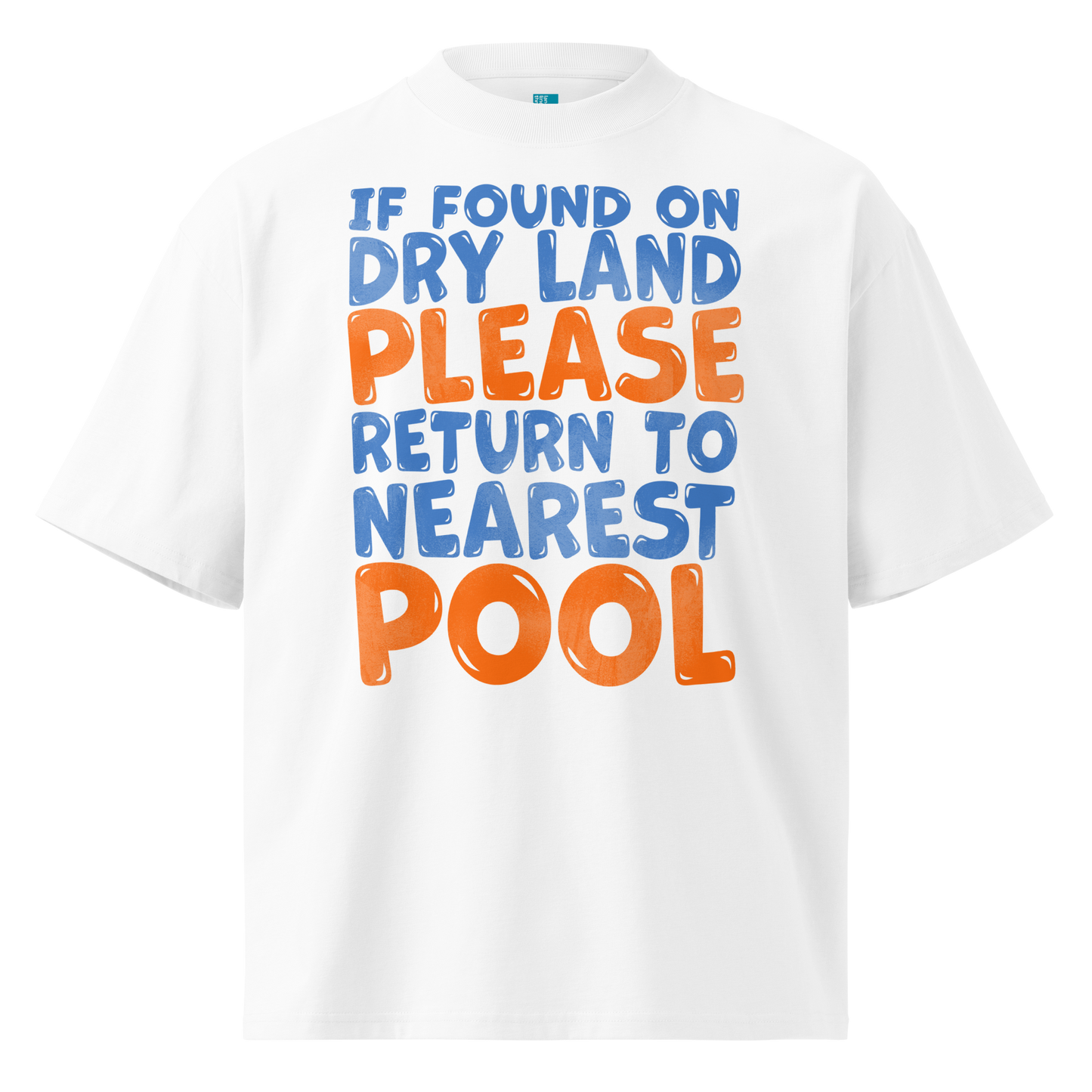 A white short-sleeve crewneck organic oversized t-shirt featuring a colorful graphic text print that reads 'IF FOUND ON DRY LAND PLEASE RETURN TO NEAREST POOL' in blue and orange bubble lettering.