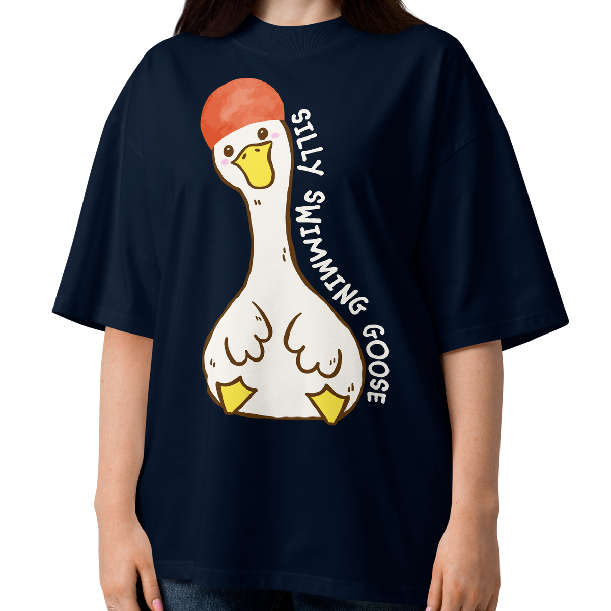 A young woman modeling a navy blue short-sleeve organic oversized t-shirt by Lane Line Threads featuring a cartoon graphic of a white swimming goose wearing a red swim cap, with the text 'SILLY SWIMMING GOOSE' printed vertically alongside it.