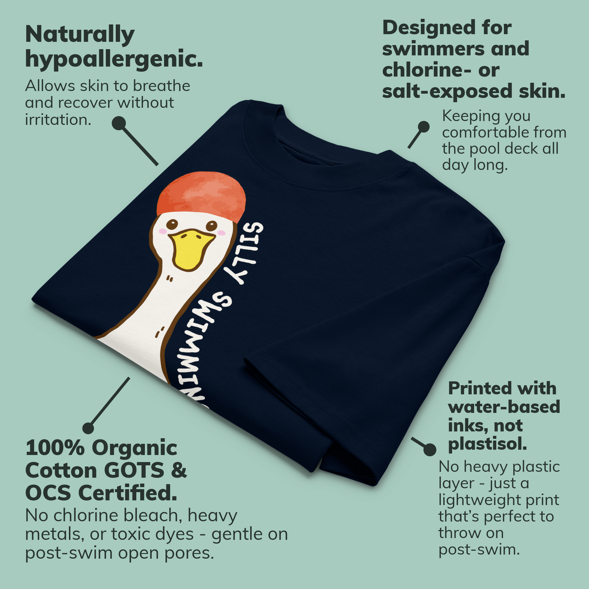 A navy blue short-sleeve organic oversized t-shirt by Lane Line Threads featuring a cartoon graphic of a white swimming goose wearing a red swim cap, with the text 'SILLY SWIMMING GOOSE' printed vertically alongside it, laid flat on a pale green background with callout text describing product benefits.