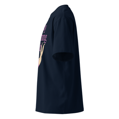 A navy blue short-sleeve organic oversized t-shirt shown from a left side profile view, featuring a graphic print on the front with purple text and a beige illustration.