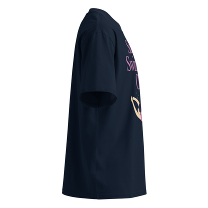 A navy blue short-sleeve organic oversized t-shirt shown from a right-side profile view, featuring a pink and gold graphic print on the front.