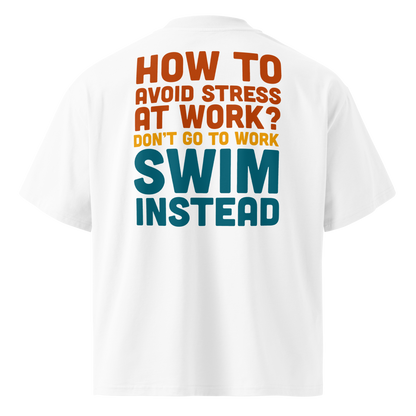 Organic oversized t-shirt with playful text: 'How to avoid stress at work? Swim instead' in vibrant colors.