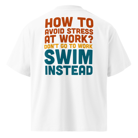 Organic oversized t-shirt with playful text: 'How to avoid stress at work? Swim instead' in vibrant colors.