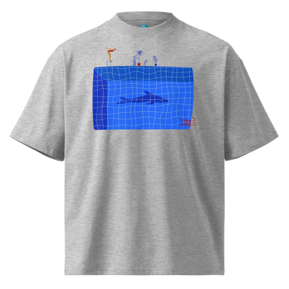 A gray short-sleeve crewneck organic oversized t-shirt by Lane Line Threads for swimmers featuring a graphic print of a blue swimming pool with a diving board, a diver, plants, and a shark on the front.