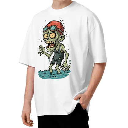 A young man with curly brown hair wearing a white short-sleeve crewneck organic oversized t-shirt by Lane Line Threads, featuring a cartoon graphic of a zombie wearing a red swim cap and goggles, standing in water.
